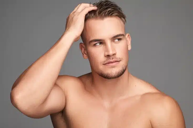 Photo de jeun homme se touchant les cheveux greffe de cheveux fut ou fue comment choisir | Dr Christophe Reinbold Lyon