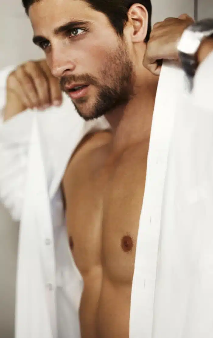 Photo stylisee d un homme entrain de porter sa chemise chirurgie esthetique pour homme | Dr Christophe Reinbold Lyon